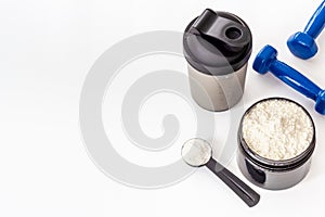 Jar with whey protein and dumbbells. Sports nutrition and food supplement