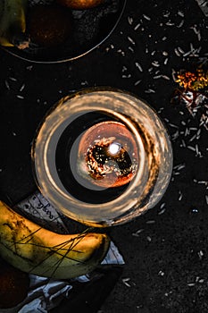 A jar is which is loaded with rose and candle on indian festival diwali deepawali with fire isolated on table