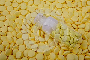 Jar of yellow pills lies on other medicines. Drugs, painkillers, colds macro