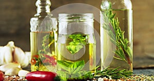 Jars and bottles with olive oil and herbs