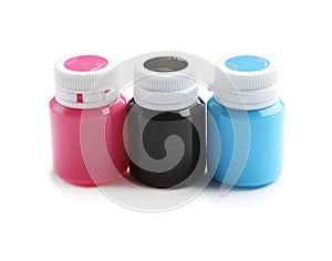 Jars with colorful paints on white background