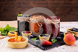 Jars with delicious summer fruits jam