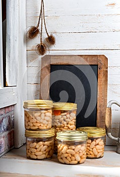 Jars of delicious white beans with chalkboard