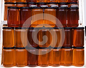 Jars of different honey varieties stocked on a shelf