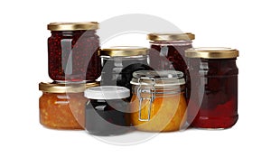 Jars with different jams on white background
