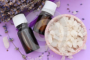 Jars with essential oils and large crystals of sea salt, top view.