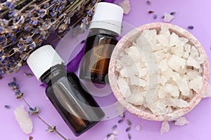 Jars with essential oils and large crystals of sea salt, top view.