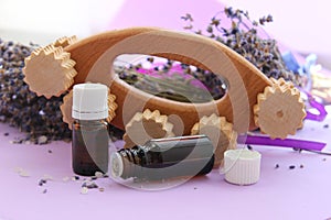 Jars of essential oils and a wooden massager to fight cellulite.