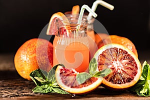 Jars of fresh blood orange juice, selective focus