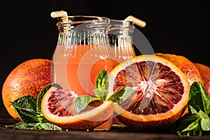 Jars of fresh blood orange juice, selective focus