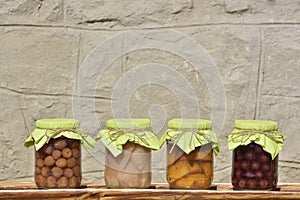 Jars with fruity compotes . Preserved fruits. photo