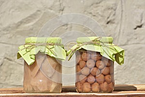 Jars with fruity compotes . Preserved fruits photo