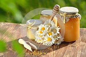 Jars full of delicious honey and bee pollen