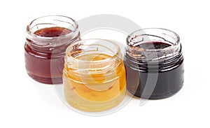 Jars full of fresh homemade colorful jams in glass
