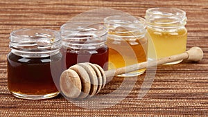 Jars full of honey wooden drizzler photo