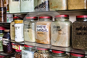Jars of herbs and powders in a indian spice shop.