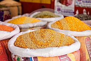 Jars of herbs and powders in a indian spice shop.