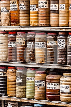 Jars of herbs and powders in a indian spice shop.