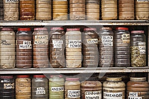 Jars of herbs and powders in a indian spice shop.
