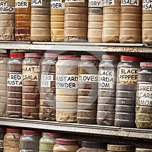 Jars of herbs and powders in a indian spice shop.