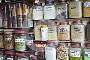 Jars of herbs and powders in a indian spice shop.