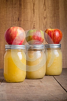 Jars of homemade applesauce with apples photo