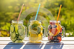 Mason jars of infused water with fruits photo