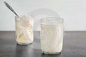 Jars with milkshake and tasty vanilla ice cream