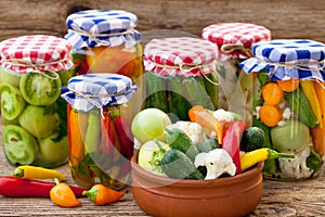 Jars with pickles, tomatoes and chillies