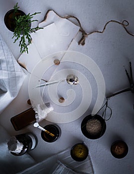 Jars of powders, leaves burnt paper, scales, a set weights on the table. top view