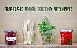 Jars reused with reuse for zero waste text on cardboard background, recycle and upcycle for sustainable living