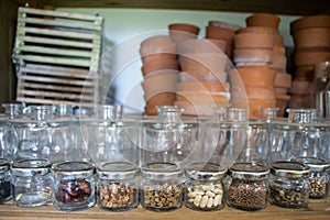 Jars of seeds on a shelf in a garden shelter