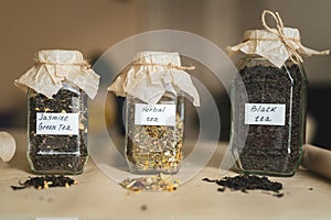 Jars with three types tea on table, alternative medicine and natural food