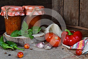 Jars of tomato sauce with chili, pepper and garlic. Bolognese sauce, lecho or adjika. Preservation. Canning