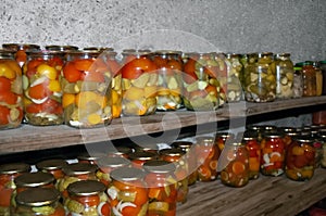 Jars of a variety of pickled vegetables . Canned foods. Preserves
