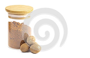 Jars of Whole and Ground Nutmeg on a White Background