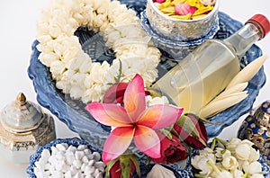 Jasmine garland and Colorful flower in water bowls decorating and scented water, perfume, marly limestone, pipe gun isolated on