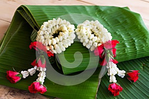 Jasmine garland of flowers on banana leaf background.