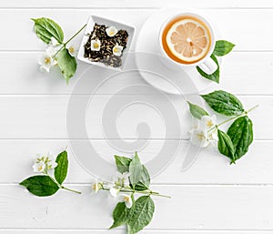 Jasmine green steaming tea, flowers, textspace, topview