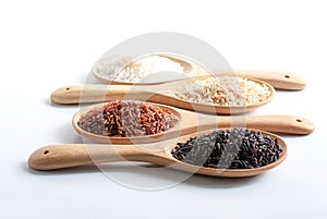 Jasmine rice, jasmine brown rice, jasmine red rice, purple-brown rice in wooden ladle.