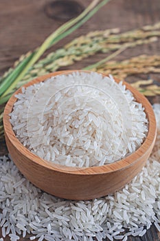 Jasmine rice in a wooden bowl with background.