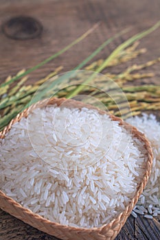 Jasmine rice in a wooden bowl with background.