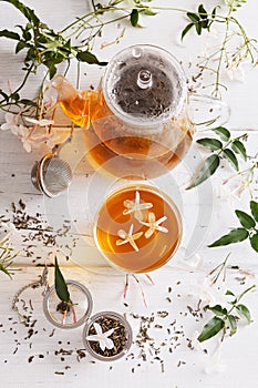 Jasmine tea over white wooden background
