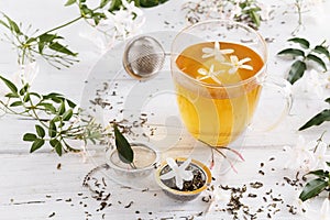 Jasmine tea over white wooden background