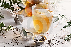 Jasmine tea over white wooden background