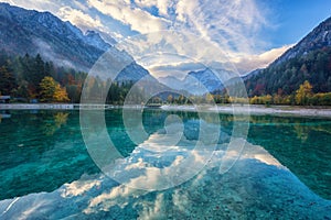 Jasna lake in Triglav national park, autumn landscape with water, mountains and sky, travel background, Kranjska Gora, Slovenia