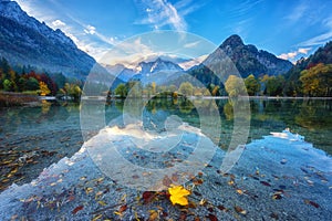 Jasna lake in Triglav national park at sunrise, Kranjska Gora, Slovenia. Amazing autumn landscape with Alps mountains