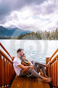 Jasper town Canada, couple at lakeshore, sunrise by the lake at Jasper , Lac Beauvert Alberta Canadian Rockies Canada