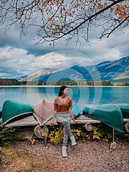 Jasper town Canada, girl at lakeshore, sunrise by the lake at Jasper , Lac Beauvert Alberta Canadian Rockies Canada