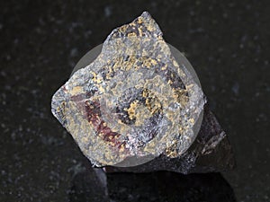 jaspilite (ferruginous quartzite) stone on dark
